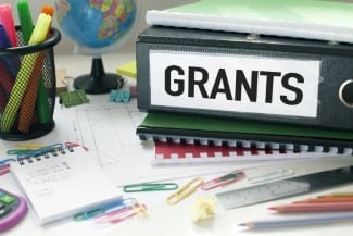 Grants and project funding concept with file on office desk