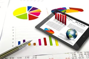 bigstock-Touch-pad-and-financial-Graphs-32535164