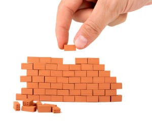 bigstock-building-a-small-brick-wall-on-20610638