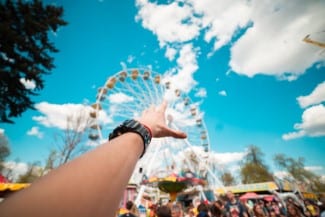 hand-reaching-the-ferris-wheel-in-amusement-park-picjumbo-com