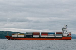 Red Container Ship Under White Clouds