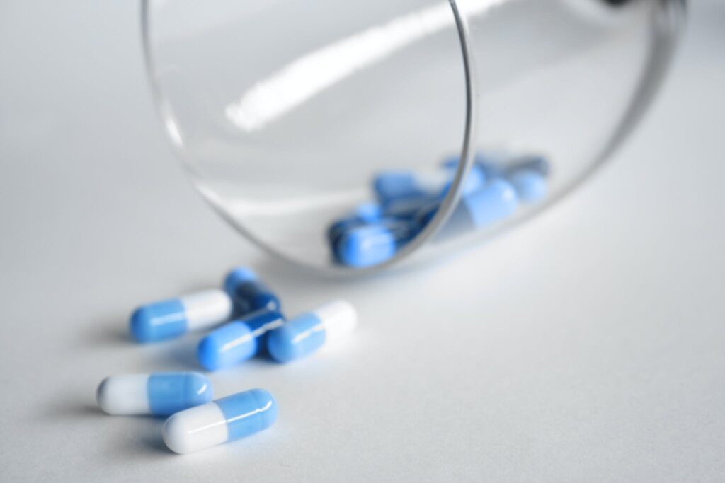 Depth Photography of Blue and White Medication Pill